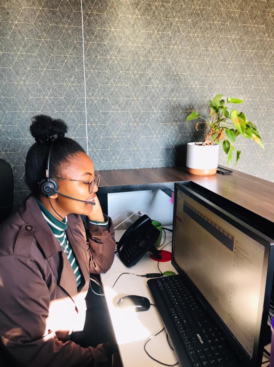 Global IT Systems helpdesk agent assisting a client by phone and headset