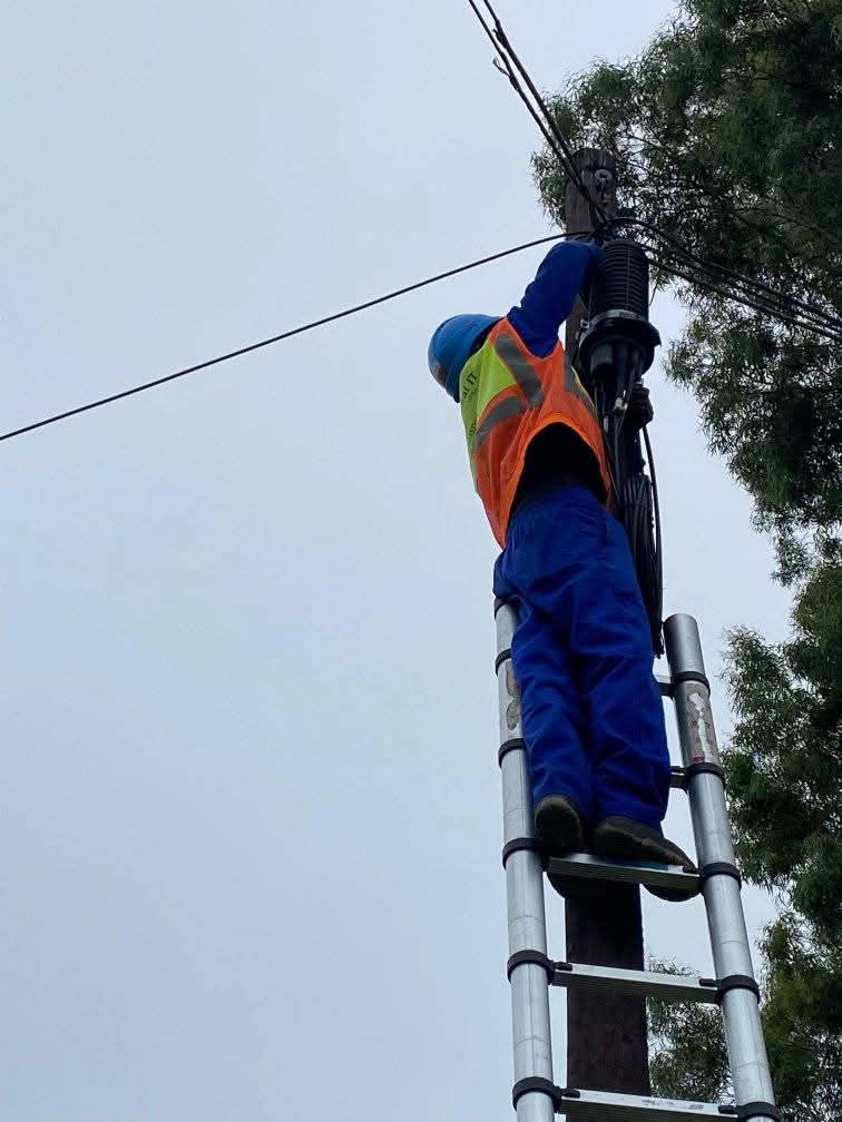 Global IT Systems technician installing pole-mounted CCTV and cabling